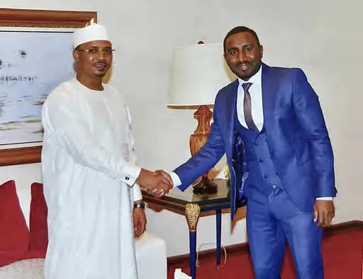 Handshake between a Prime Gate Africa representative and a Chadian official during a presidential audience