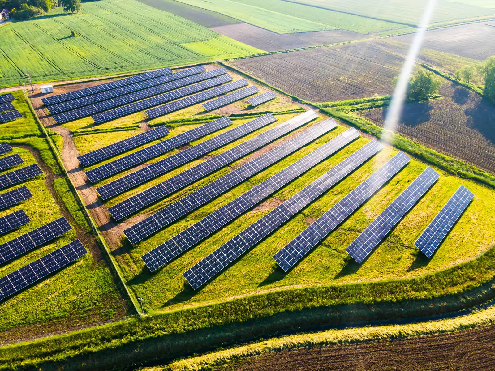 Aerial view of a large-scale solar power plant set in farmland